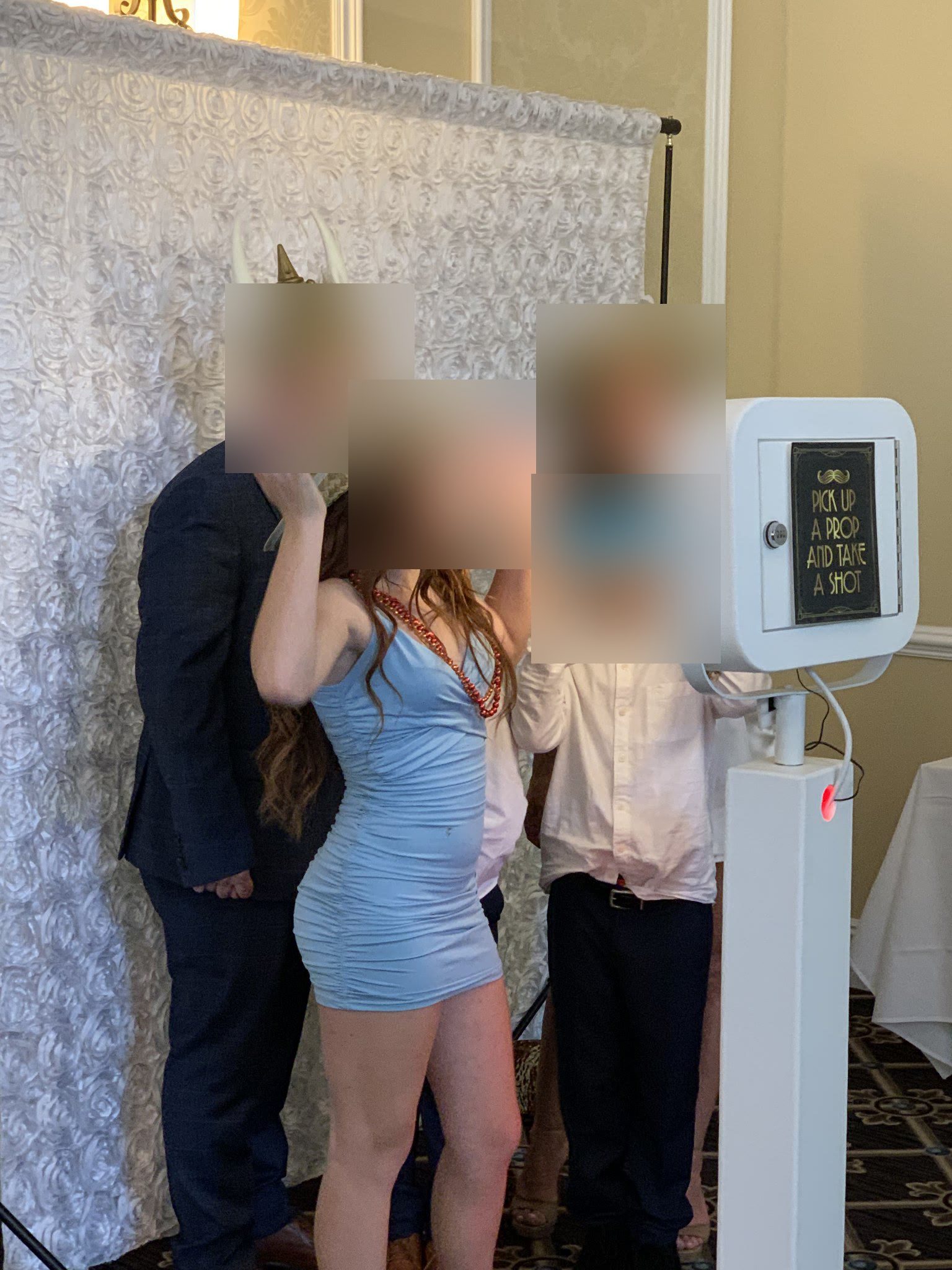 Family enjoying the selfie photo booth (faces blurred for privacy)